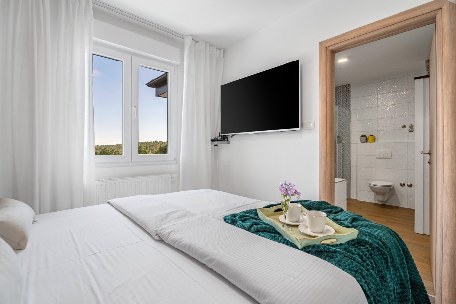 Bedroom No1 with a queen-size bed 160cm x 200cm, a flat screen TV, and an en-suite bathroom, views of the pool