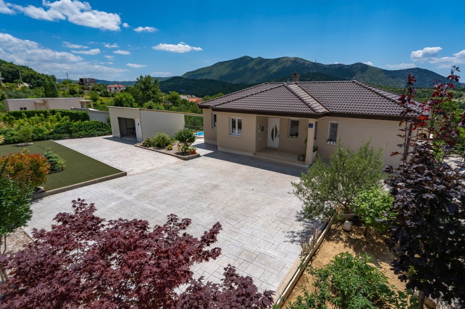 From the parking side is a covered area with billiards (pool table) and table tennis