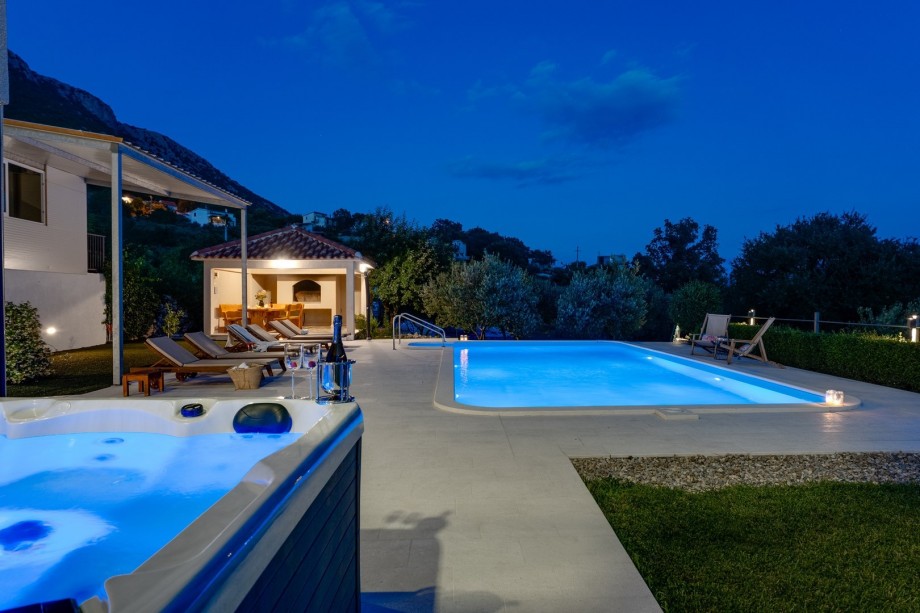 Comfortable and covered outdoor dining area with a traditional barbecue