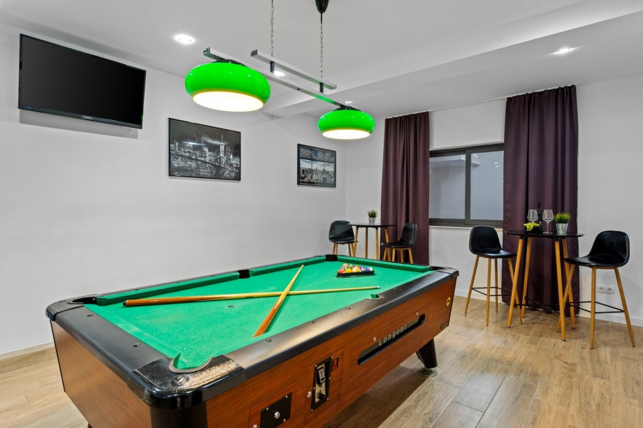 Billiards and gym at lower ground floor, garage level