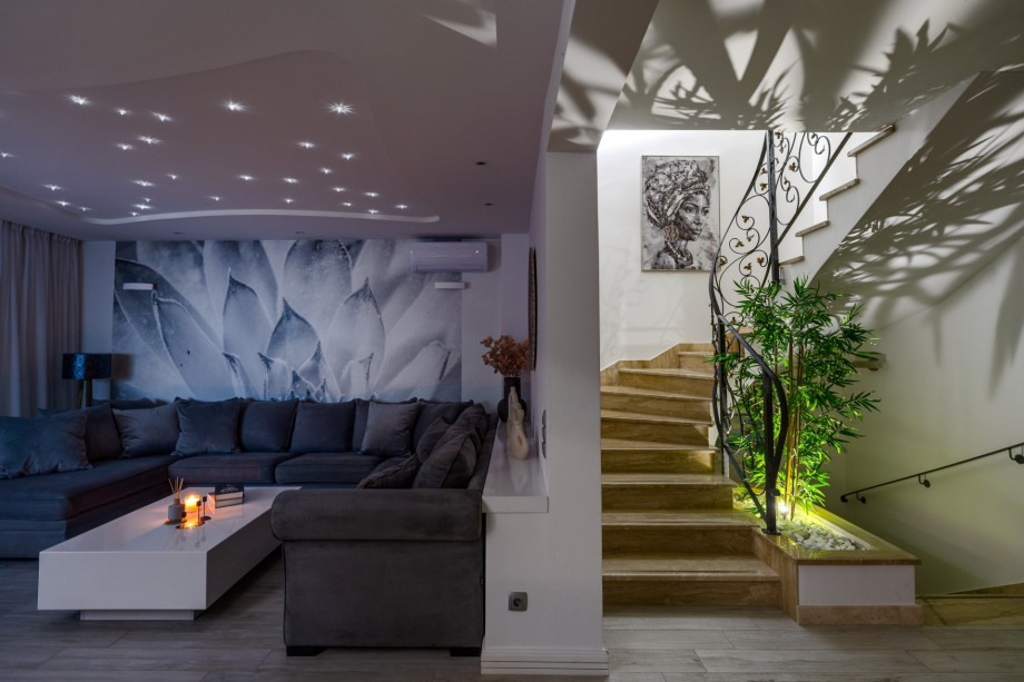 Spacious living room with free WiFi, TV, A/C and stairs for upper floors