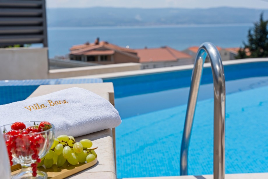 Private heated pool and 6 comfortable lounge chairs, open sea view