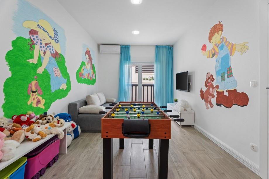 Playroom with a lot of toys, table soccer, play console, sofa bed for two, 1st floor
