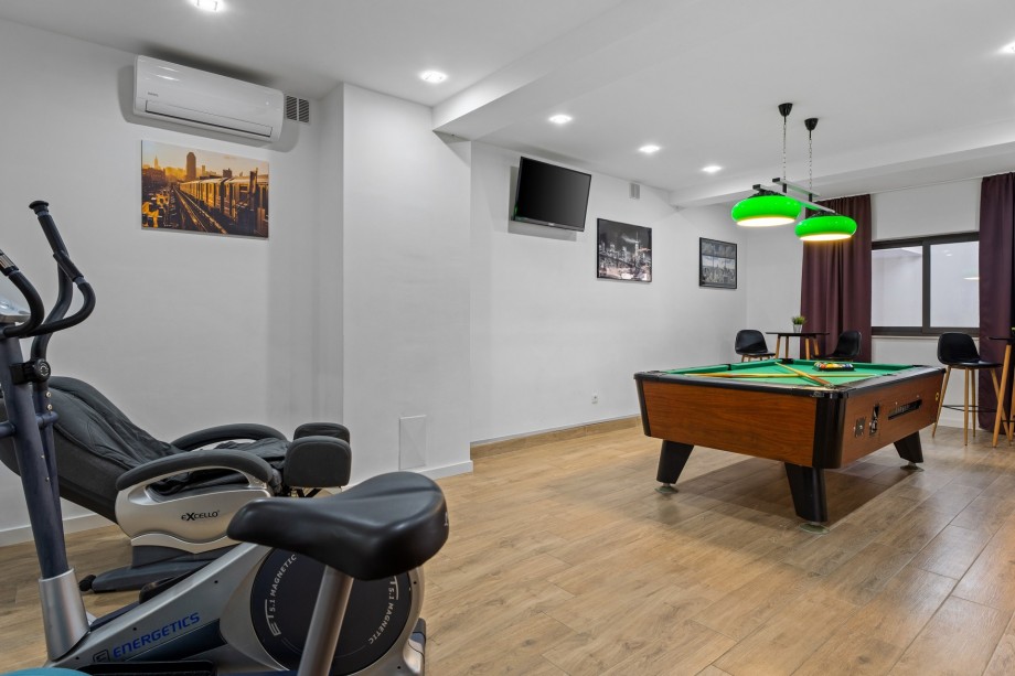 Billiards and gym at lower ground floor, garage level