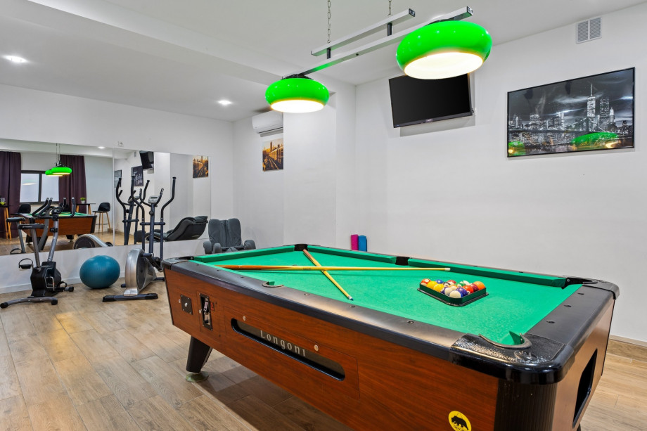 Billiards and gym at lower ground floor, garage level