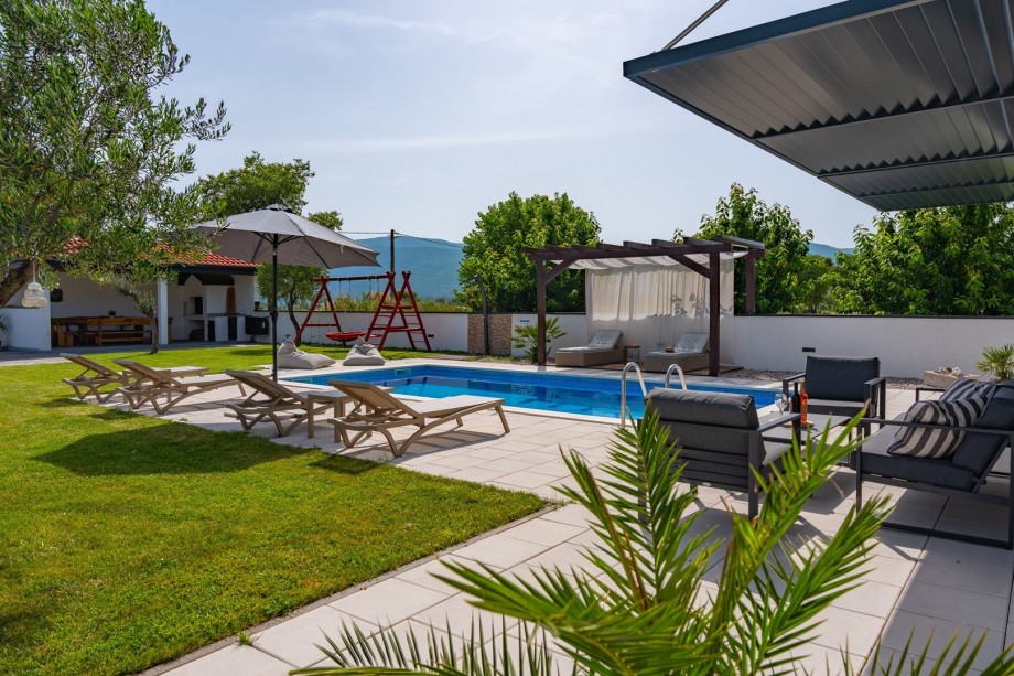 Private 32sqm heated swimming pool, a sun deck area with 6 deck chairs, 2 sun umbrellas, an outdoor shower