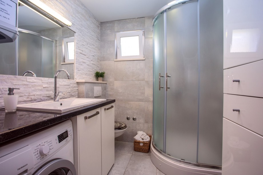 Bathroom with shower and washing machine
