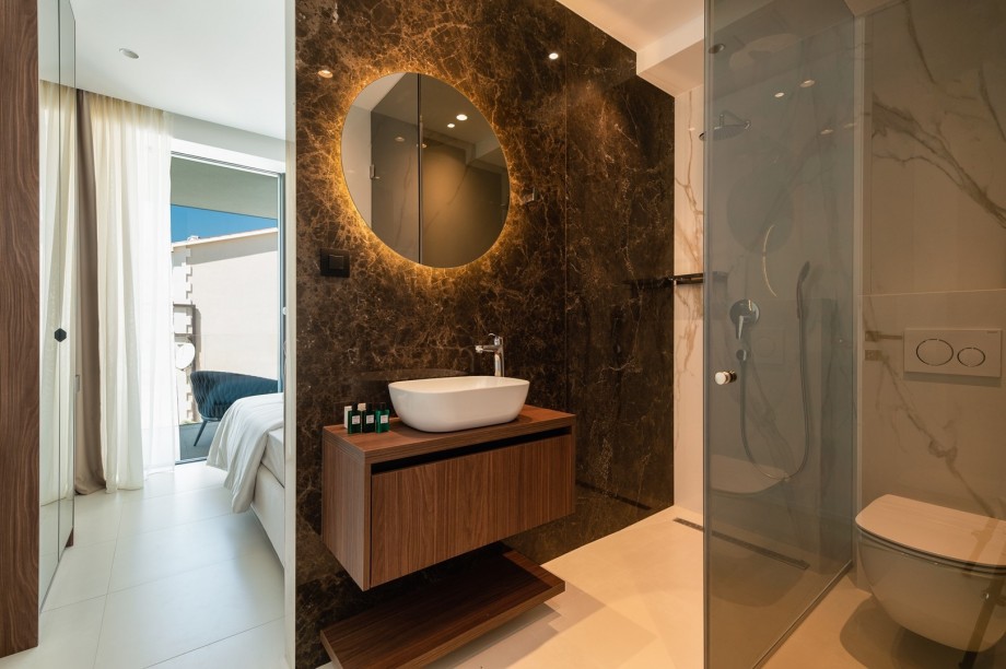 An en-suite bathroom with a shower, a sink, and a toilet