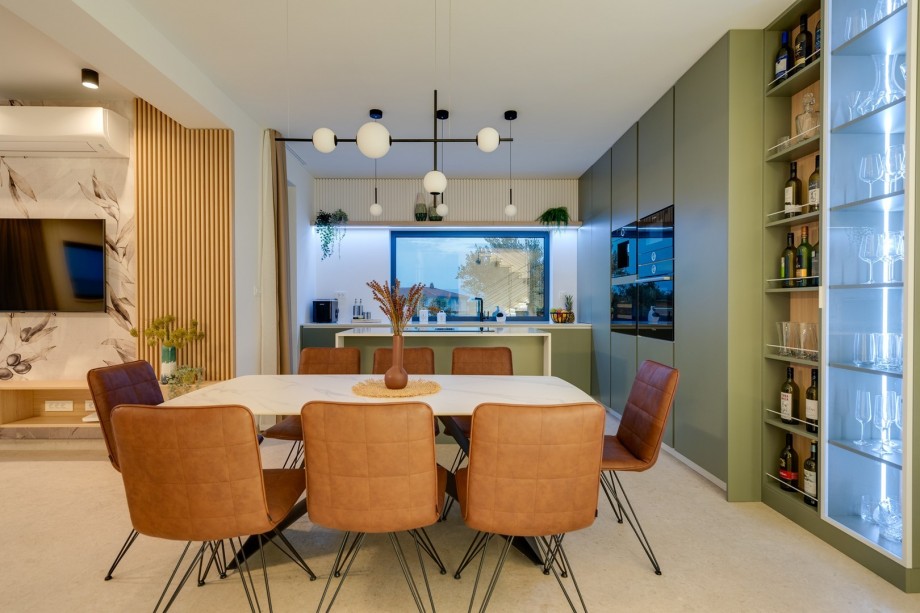 A fireplace, a direct exit to the outdoor dining area and pool