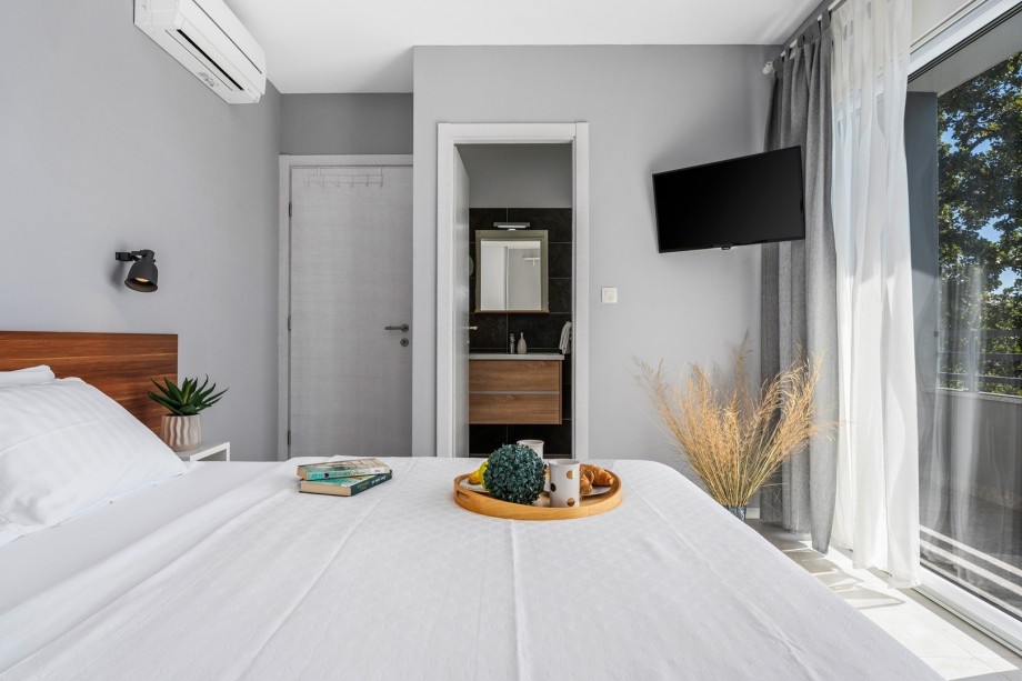 Bedroom NO3 with exit to a partially covered terrace with a lounge corner and panoramic views of town Split