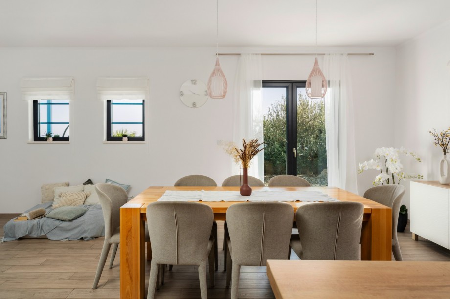 Dining area with exit to outdoor dining area and pool
