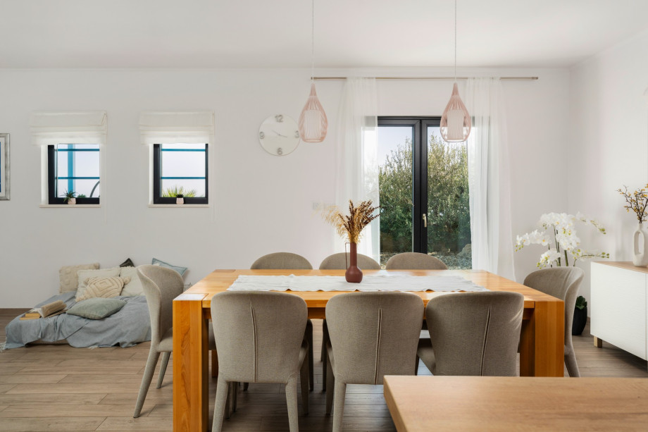 Dining area with exit to outdoor dining area and pool