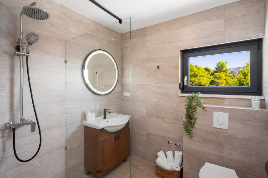 Family bathroom with shower at bedroom level