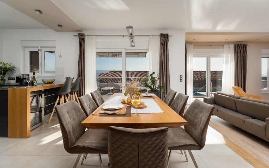 Dining table for 8 and fully equipped kitchen that is connected to the pool area
