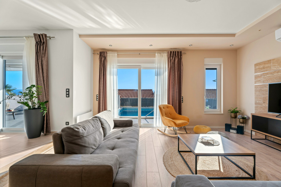 Comfortable living room with direct exit to the pool area