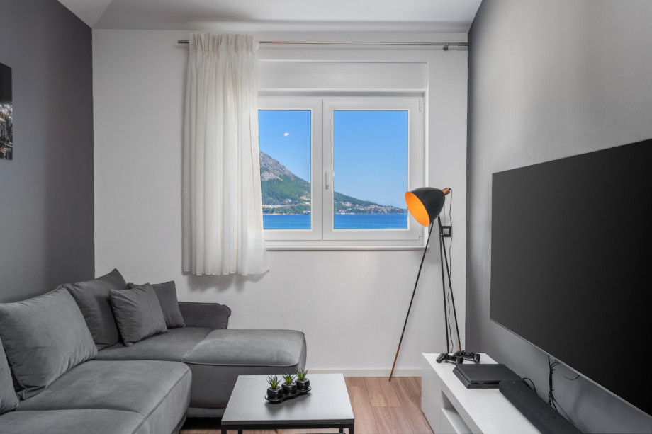 Media room with PS4, flatscreen TV and soundbar