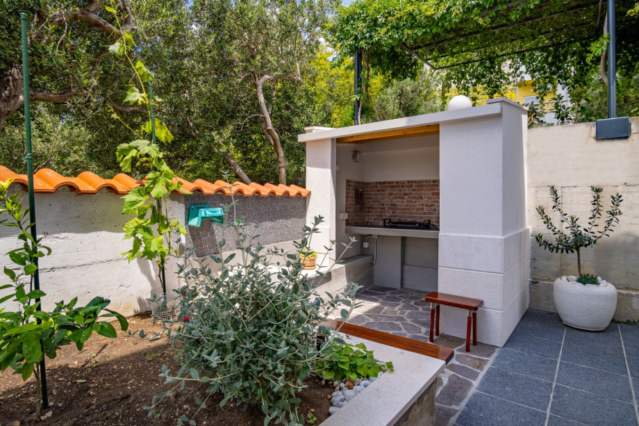Traditional and electric grill next to the property