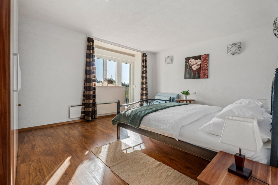 A Bedroom NO2  with a king size bed, a sofa (can convert into a sofa bed for one person), air-conditioning and a balcony with pool views