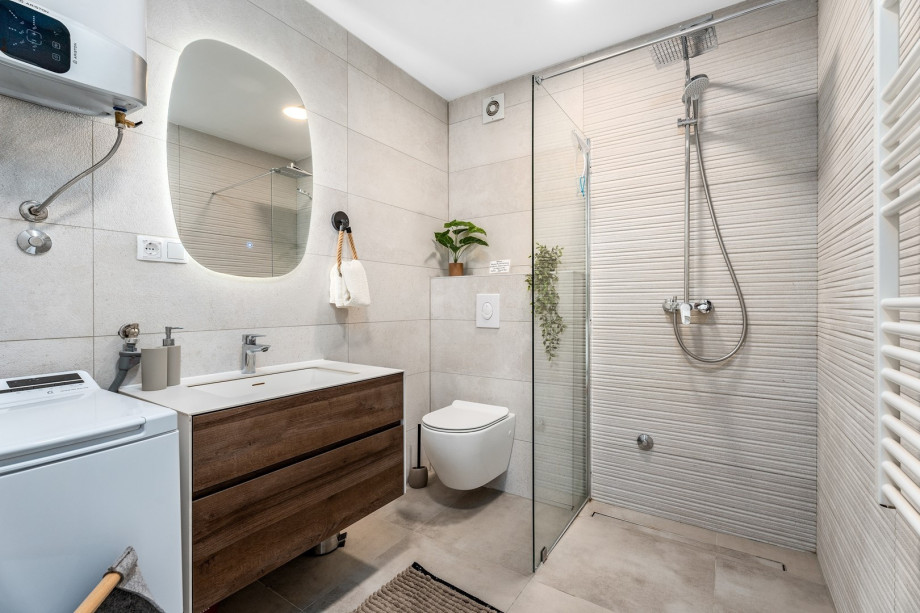 Bathroom with a shower, toilet, and a sink