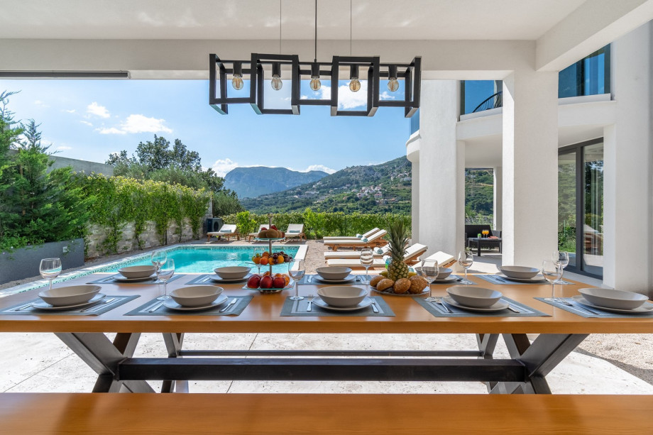 Spacious pool area with 8 pool chair, solar shower, outdoor dining area and amazing view