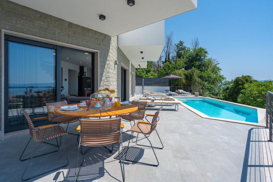 outdoor dining area next to the pool