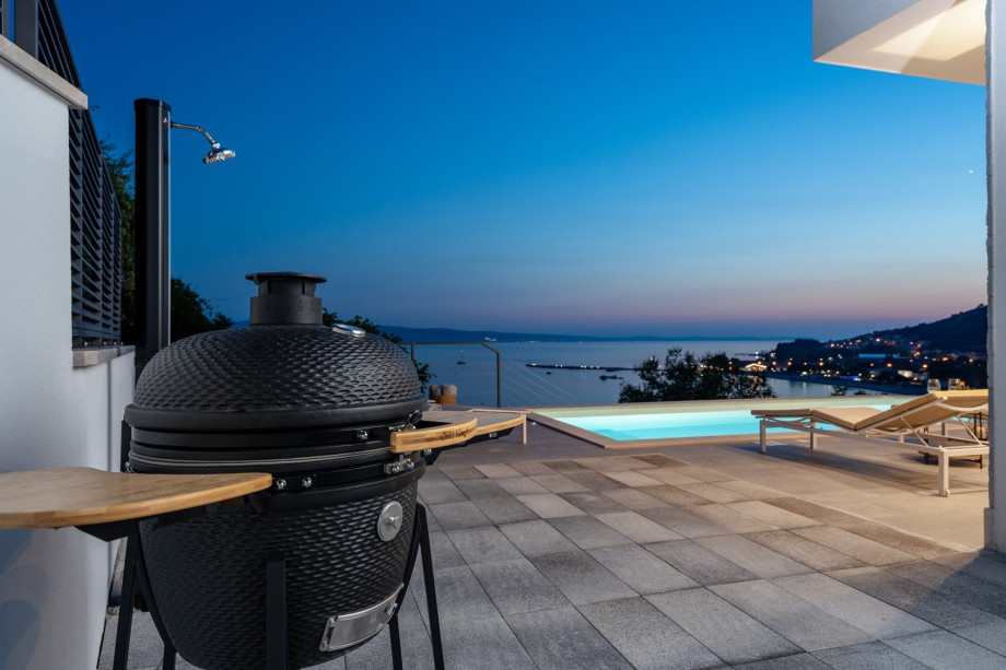 outdoor dining area with a Kamado charcoal grill