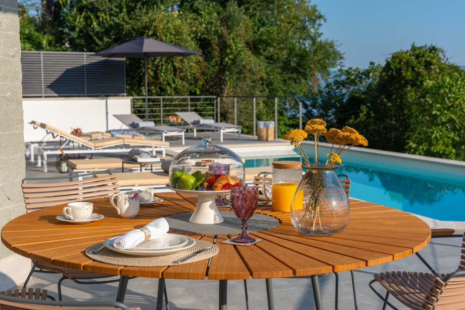 outdoor dining area next to the pool