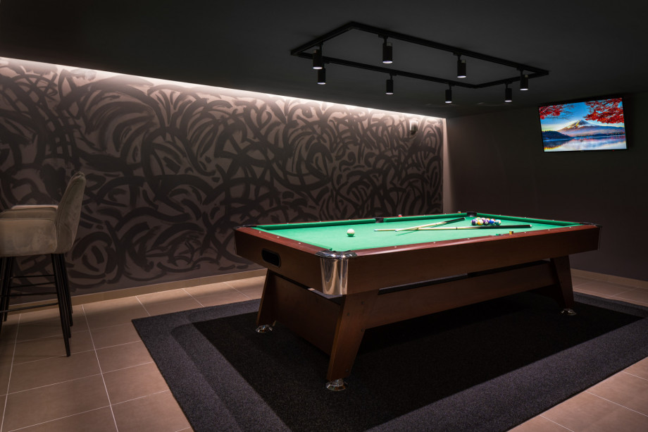 Next to the parking there is a game room with billiard table and TV
