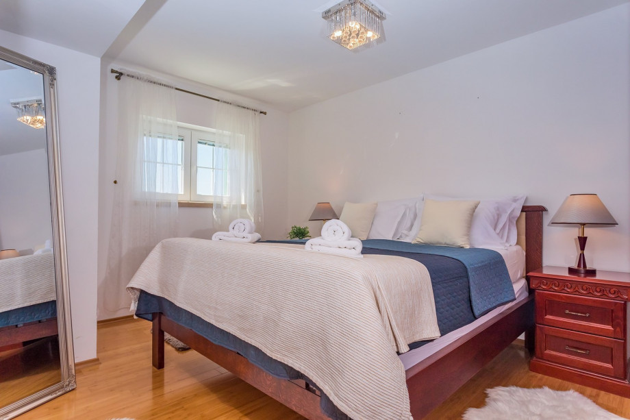 Bedroom No.2 with double bed, TV, and en-suite bathroom with shower (pool level)