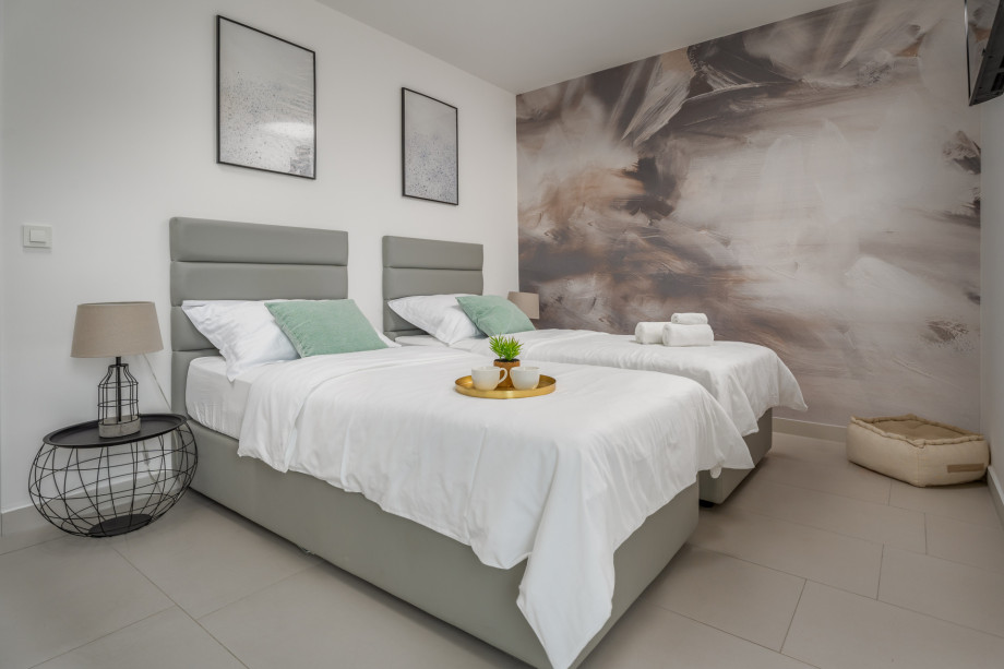 Bedroom No.2 on 1st floor with two single beds 90x200cm,  AC, TV, balcony