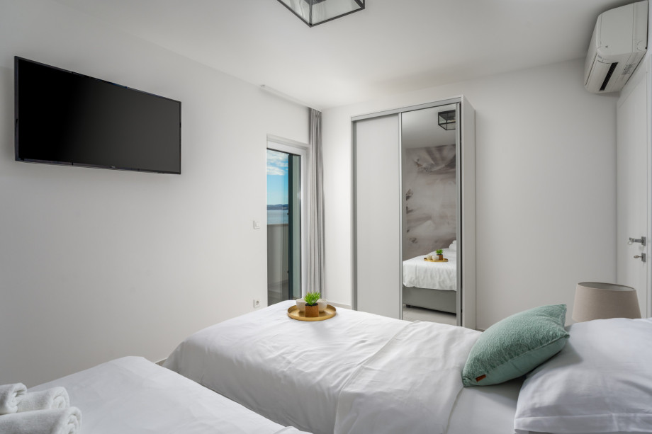 Bedroom No.2 on 1st floor with two single beds 90x200cm,  AC, TV, balcony