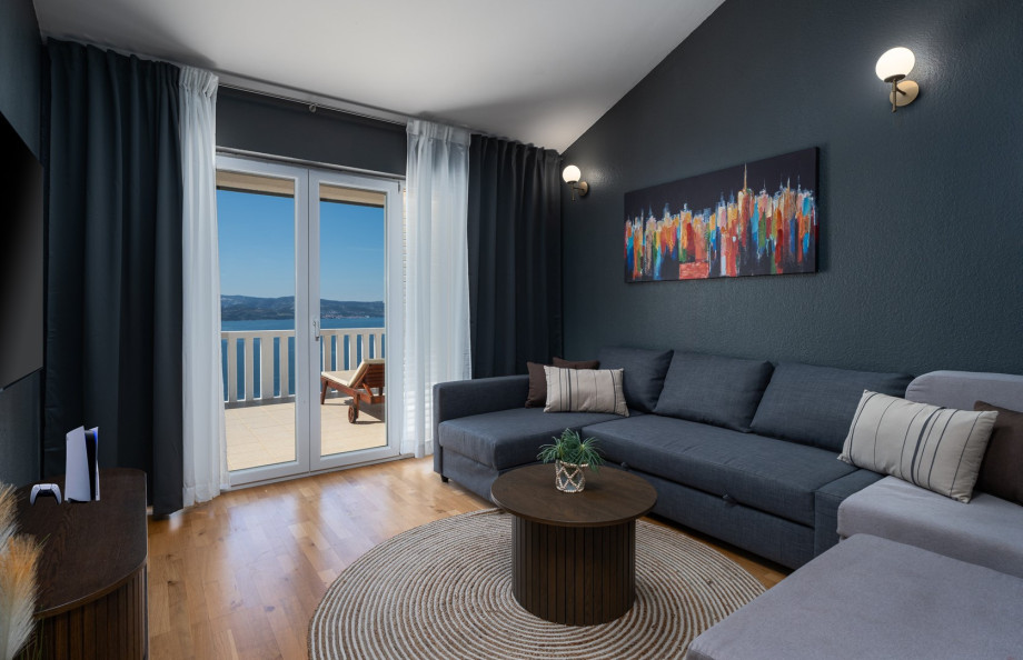 Media room with 3 sofa beds for four guests, and a big TV with PlayStation5