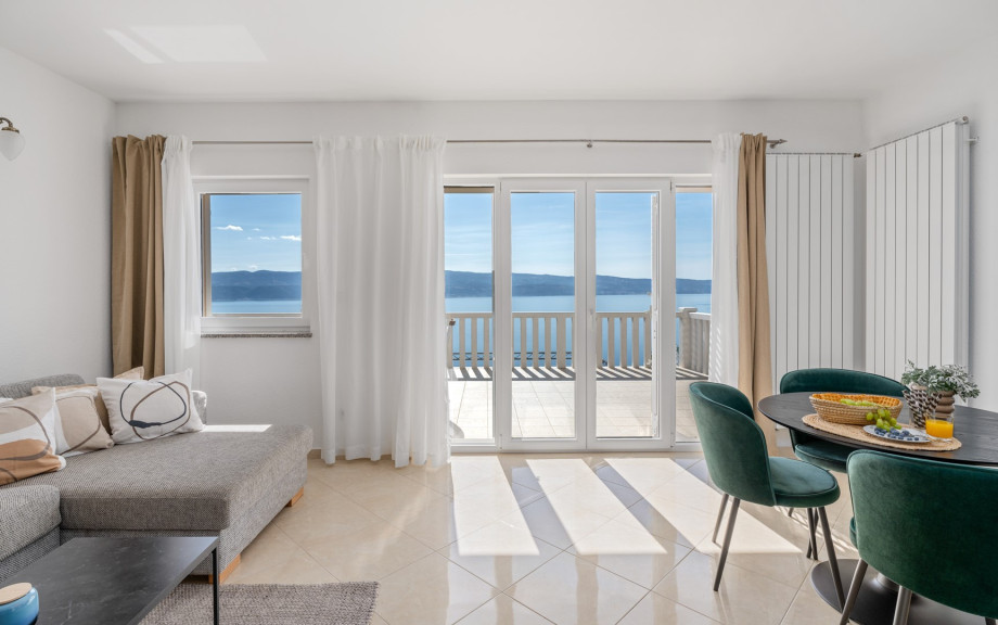 Dining and living area with sofa bed, direct exit to the balcony with open sea view