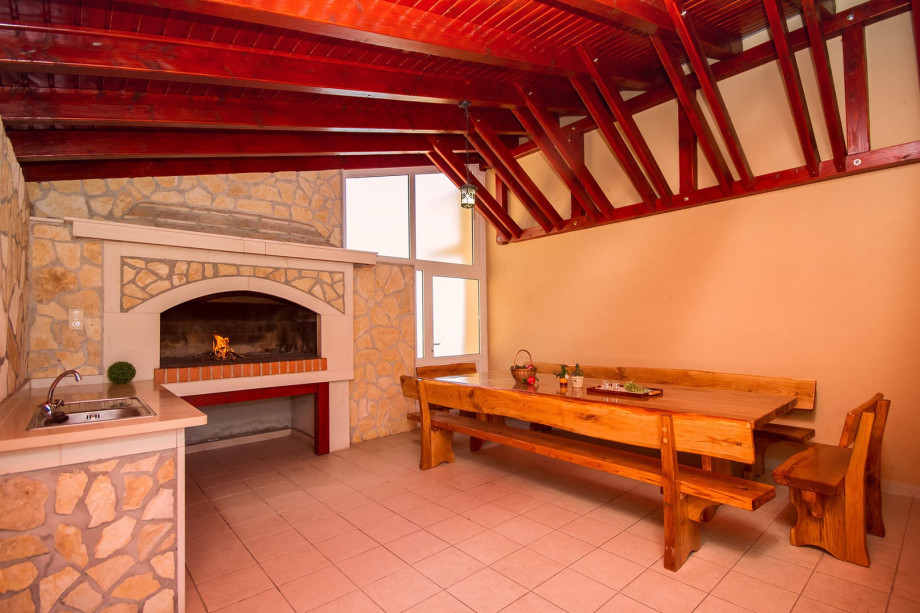 Grill and covered dining area next to the pool, dining place for 18 persons