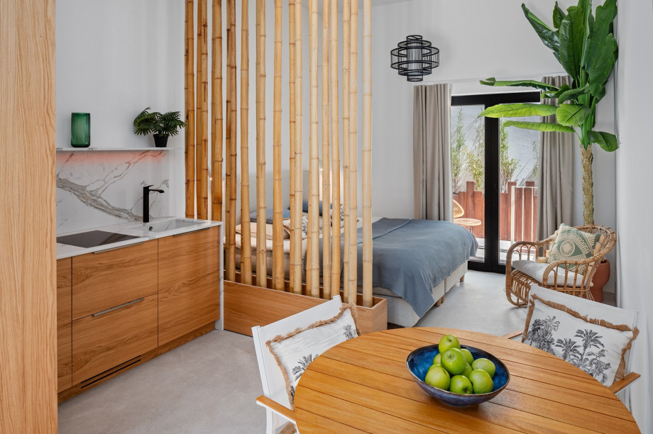 A mid-floor studio is attached to the house and features an air-conditioned living area with a fully functional kitchen, a dining table