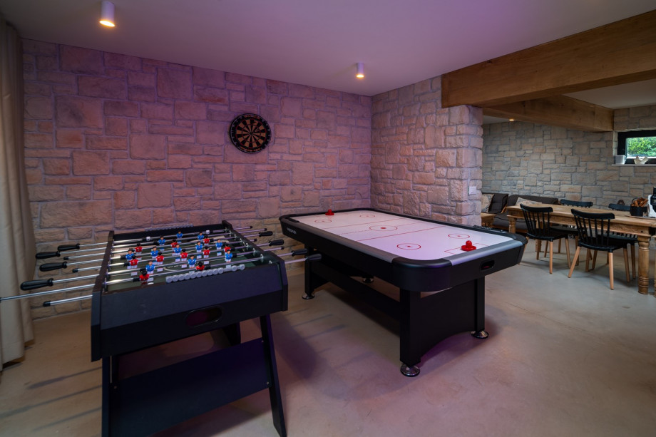 On the lower ground floor, next to the sun deck area and the barbecue, there is a traditionally decorated room