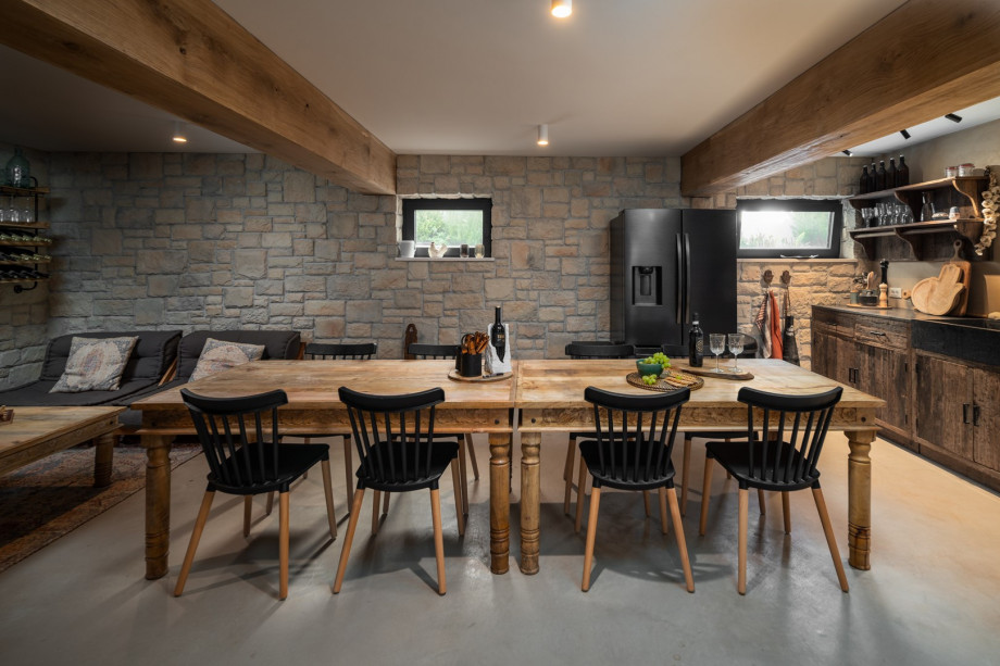 A fully functional retro kitchen, a ten-person wooden dining table, a flat-screen TV-equipped sofa, Air Hockey, table soccer, darts