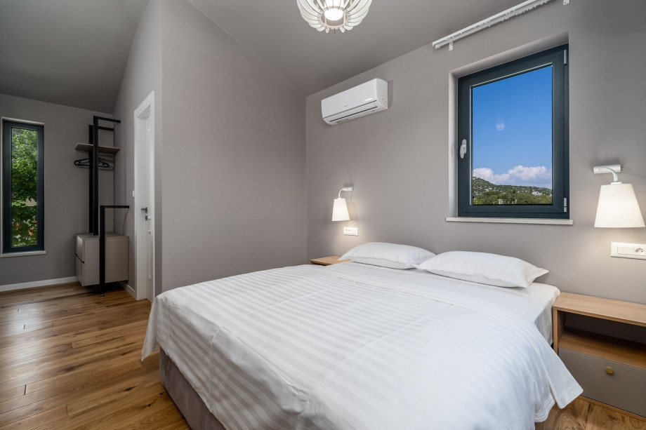 The first floor offers a Bedroom No2 with a queen size bed 160cm x 200cm, air-conditioning, a TV, en-suite bathroom with a shower