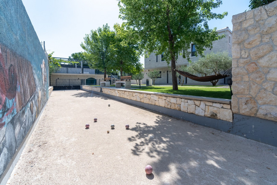 In addition, behind the house, next to the traditional bocce court that is for your use exclusively, and next to the lovely courtyard with trees