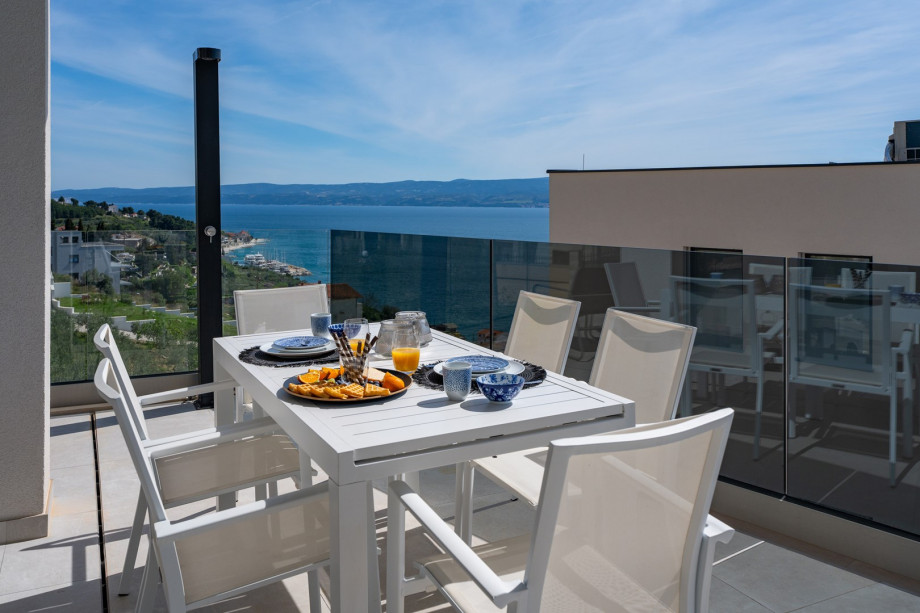 Covered outdoor dining table with sea views