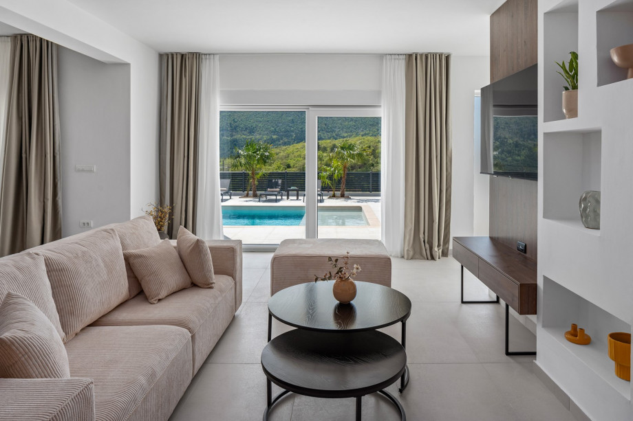 living room complete with comfy sofas, a smart TV, and a PlayStation 5