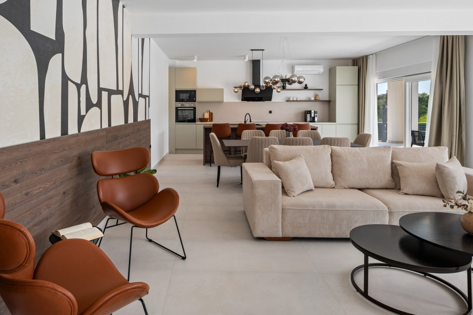 open-plan kitchen and living room complete with comfy sofas, a smart TV, and a PlayStation 5