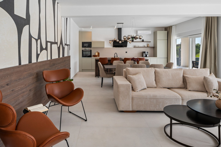 open-plan kitchen and living room complete with comfy sofas, a smart TV, and a PlayStation 5