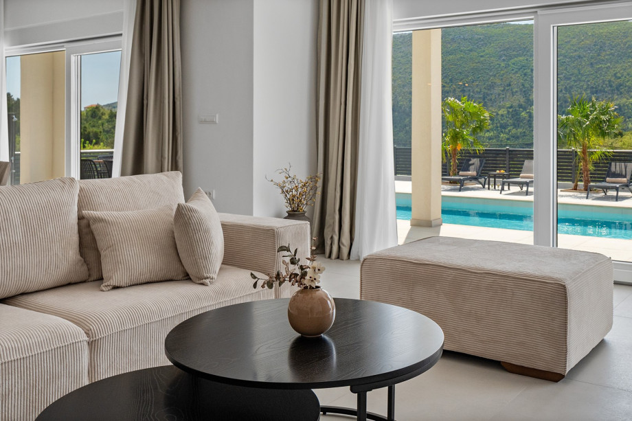 living room complete with comfy sofas, a smart TV, and a PlayStation 5