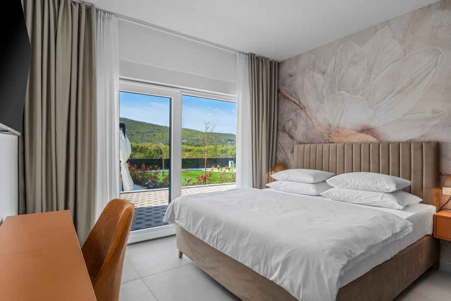 The Bedroom NO1 has a 180x200 king-size bed, A/C, TV, glass door leading to the pool area and an attached bathroom with a shower