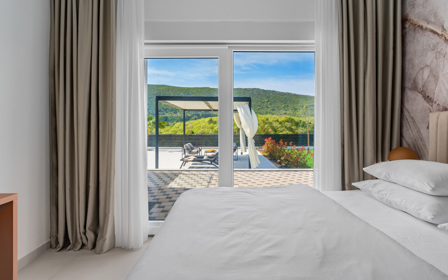 The Bedroom NO1 has a 180x200 king-size bed, A/C, TV, glass door leading to the pool area and an attached bathroom with a shower