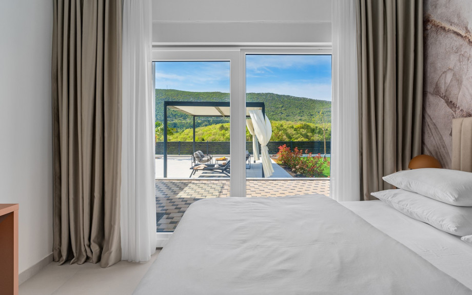 The Bedroom NO1 has a 180x200 king-size bed, A/C, TV, glass door leading to the pool area and an attached bathroom with a shower