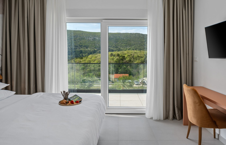 The Bedroom NO2 with a king size bed, A/C, a TV, an en-suite bathroom with a shower, and a terrace overlooking the pool and natural surroundings