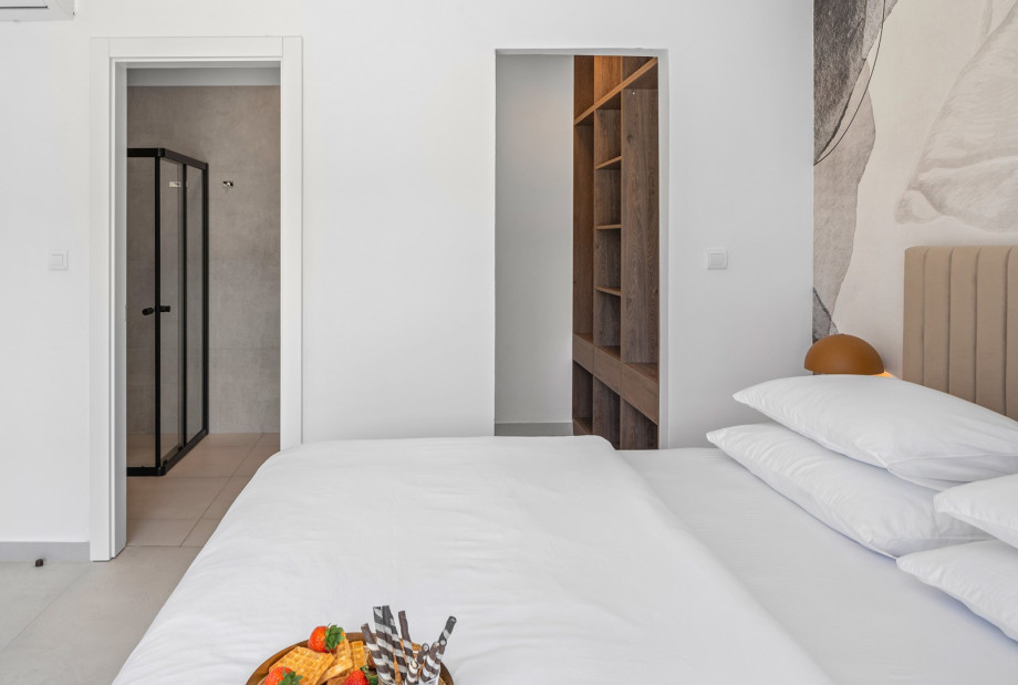 The Bedroom NO2 with a king size bed, A/C, a TV, an en-suite bathroom with a shower, and a terrace overlooking the pool and natural surroundings