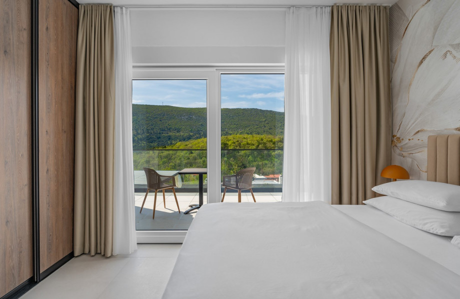 The Bedroom NO5 with a king size bed, A/C, a TV, an en-suite bathroom with a shower, and a terrace overlooking the pool and natural surroundings